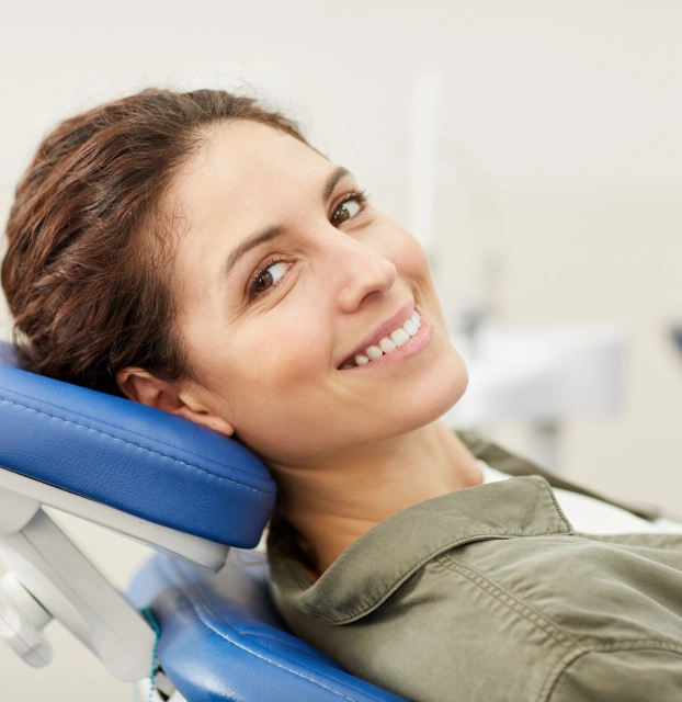 Relaxed female patient resting comfortably in a dental chair during a procedure.