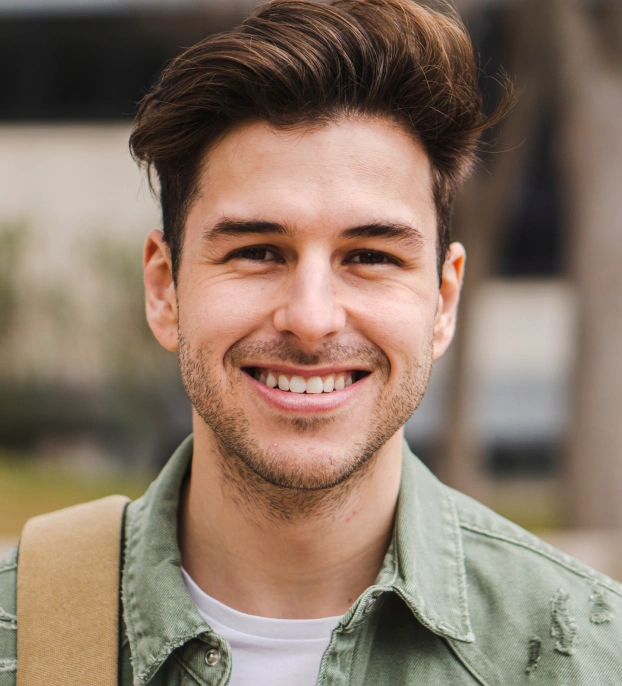 Close-up portrait of a smiling man with clean, healthy teeth.