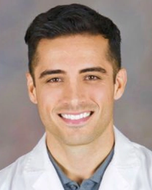 Portrait of Dr. Benjamin smiling confidently in the dental office