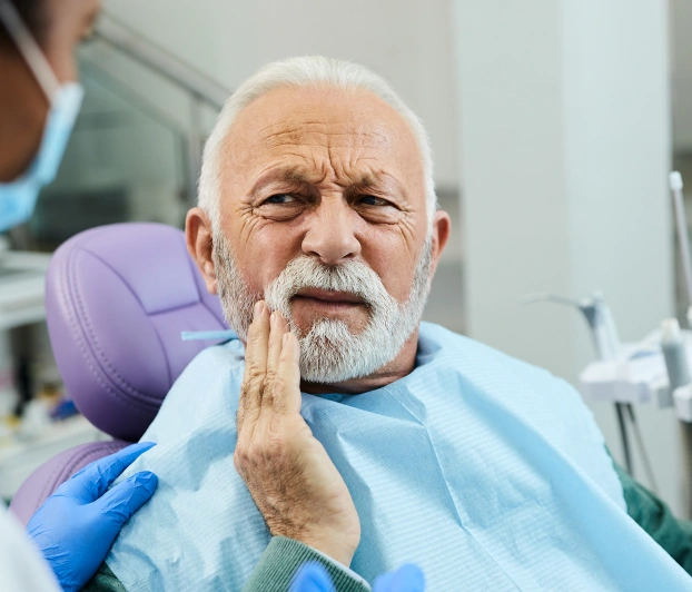 Senior patient feeling pain before tooth extraction treatment