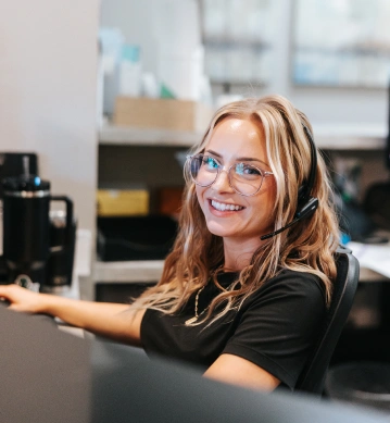 Front desk staff member answering calls at Oregon Smile Care Center